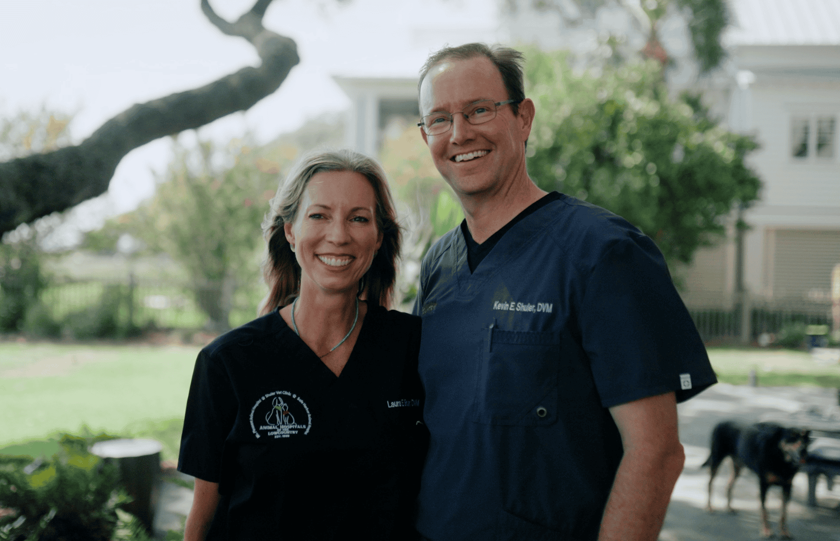 Two smiling veterinarians in scrubs standing outdoors | local vet near me | Safe Harbor Animal Hospital | Mount Pleasant SC